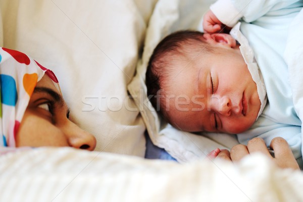 Newborn baby sleeping on bed with mom Stock photo © zurijeta