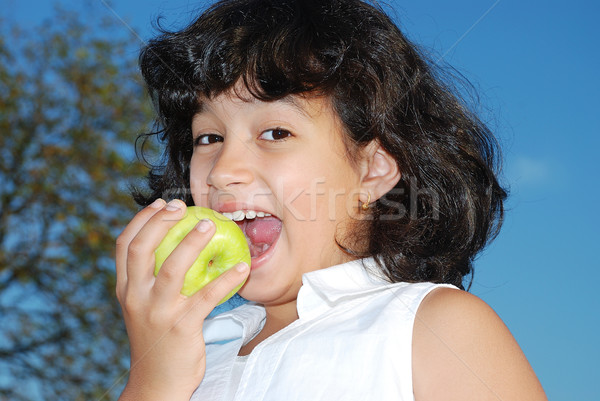 Cute little girl is eating an apple Stock photo © zurijeta