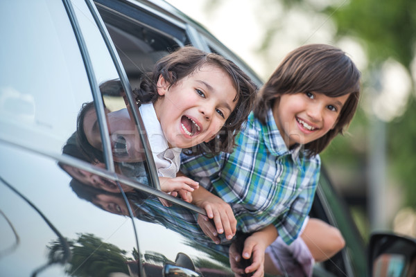 Smiling kids looking through car window Stock photo © zurijeta