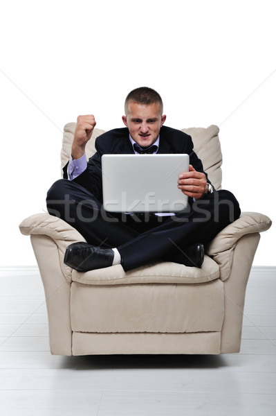 Young man surprised and happy with something he see on his laptop Stock photo © zurijeta