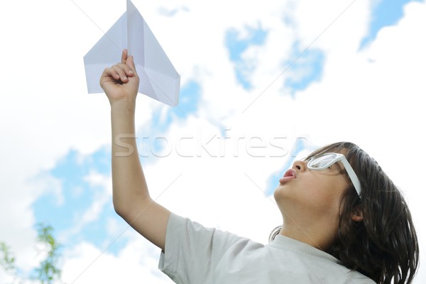 Kid flying a paper airplane Stock photo © zurijeta