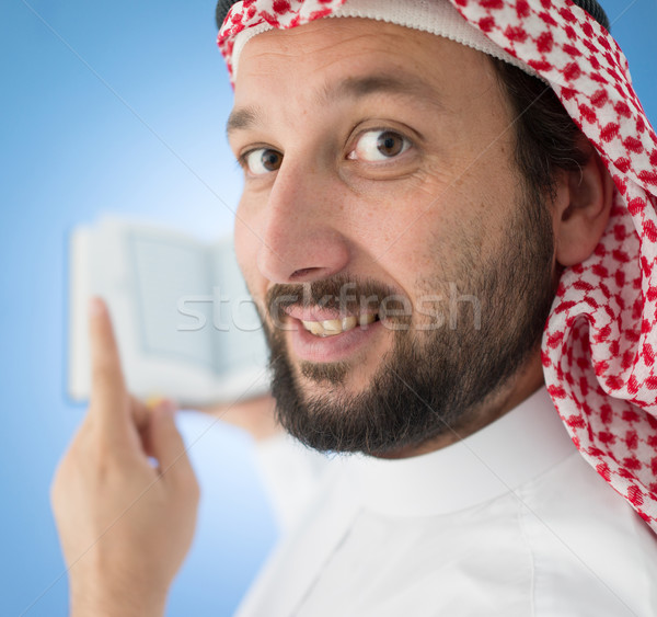 Arabic man praying with Koran Stock photo © zurijeta