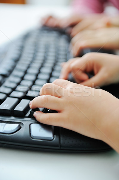 Child hands typing on keyboard Stock photo © zurijeta