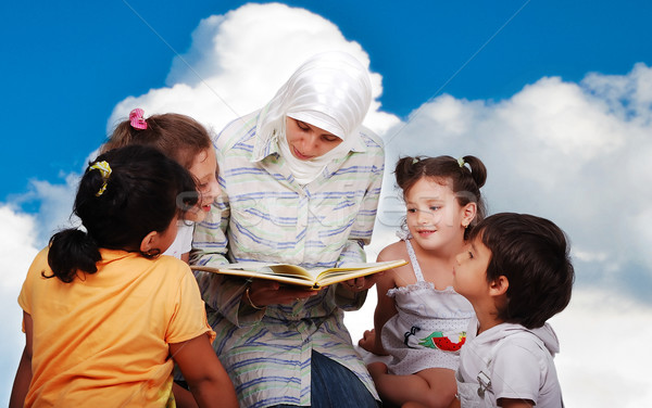 Stock photo: A young muslim woman in traditional clothes in education process