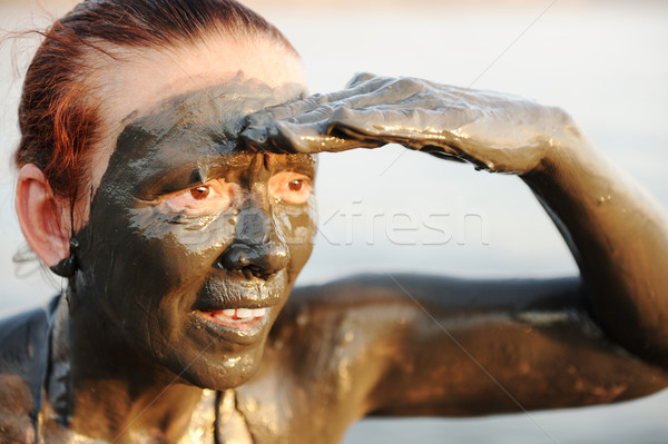 Elderly woman in a bathing suit of natural mineral mud sourced from the dead sea in Jordan Stock photo © zurijeta