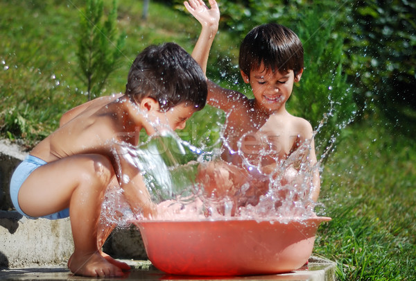 Very cute child playing with water outdoor Stock photo © zurijeta