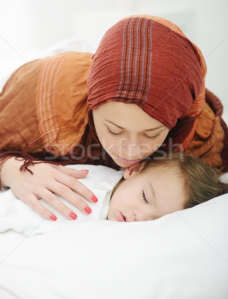 Arabic Muslim mother playing and taking care of her baby Stock photo © zurijeta