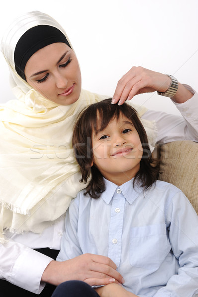 Muslim arabic covered mother and son relaxing at the home Stock photo © zurijeta