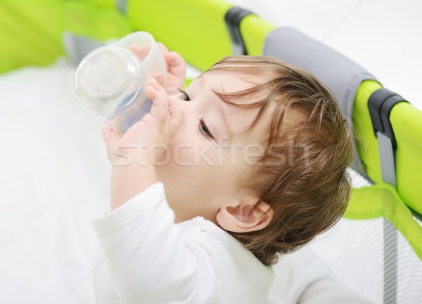 Beautiful little baby with a milk bottle in bed Stock photo © zurijeta
