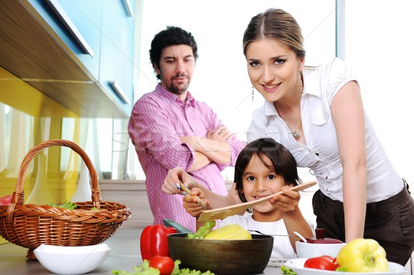 Happy family in the kitchen cooking dinner together Stock photo © zurijeta
