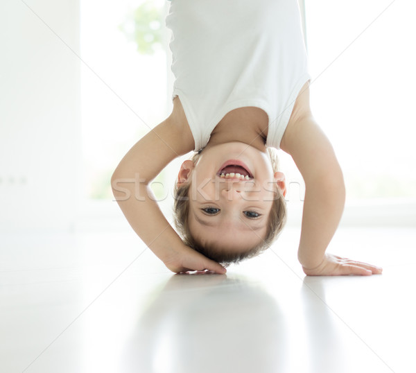 Happy little baby boy upside down laughing at home Stock photo © zurijeta