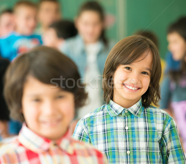 Happy children group with arms outstretched in school classroom Stock photo © zurijeta