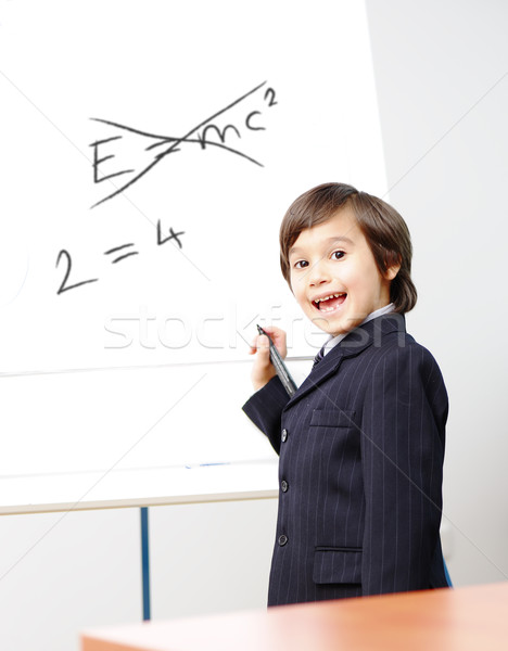 Genius little boy writting E=mc2 on the board, new formula instead, conceptual idea Stock photo © zurijeta