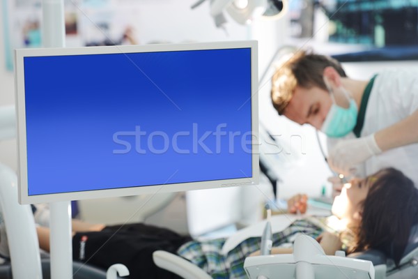 Young dentist at work in the office Stock photo © zurijeta