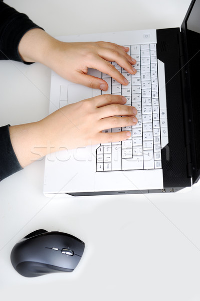 Close-up of female hand on mouse while working on laptop Stock photo © zurijeta