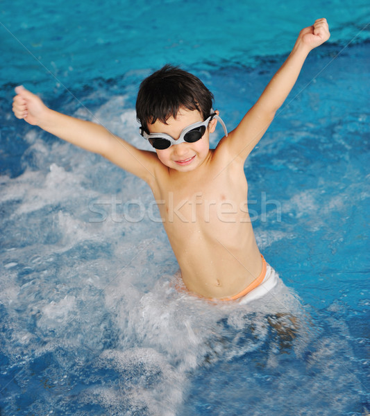 Little cute  boy in blue water of the swimming pool, summer time for fun  Stock photo © zurijeta