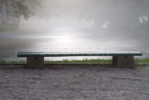 A bench aside the river in morning time Stock photo © zurijeta