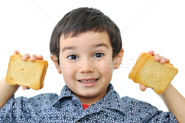 Little boy showing satisfaction while making a peanut butter sandwich Stock photo © zurijeta