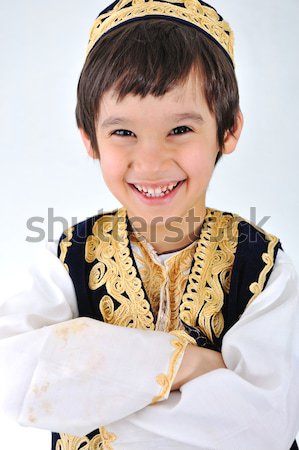 Stock photo: Little kid in middle-eastern clothes making peace gesture