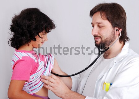 Young male doctor in white has some medical activities Stock photo © zurijeta