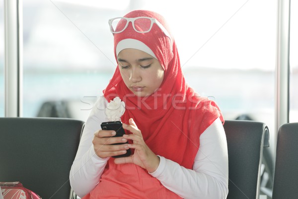 Arabic Middle eastern teenage girl using cell phone for messagin Stock photo © zurijeta