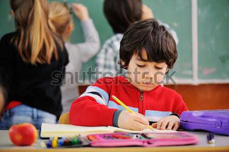 Cute lovely school children at classroom having education activi Stock photo © zurijeta