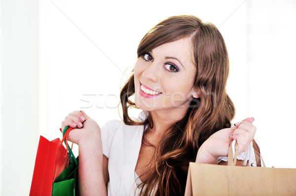 Beautiful girl holding many shopping bags and smiling Stock photo © zurijeta