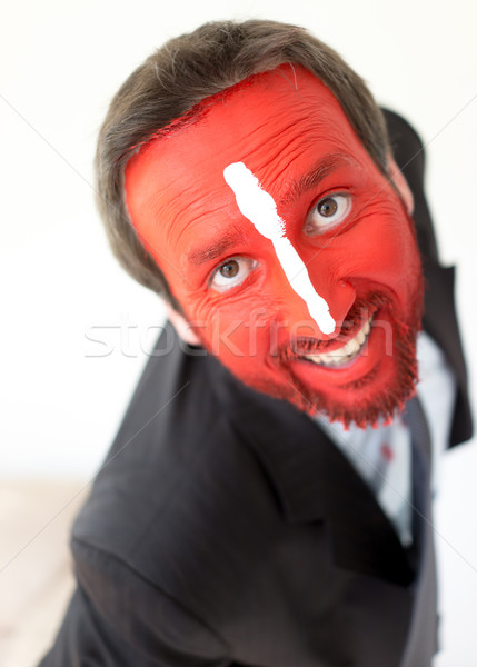 Stock photo: Painted man with red face and white line on nose
