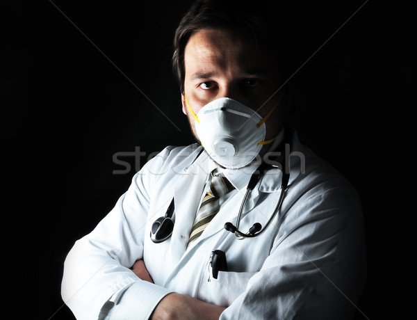 Young attractive male doctor in characteristic clothes with a mask Stock photo © zurijeta