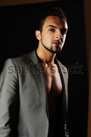 Young modern style macho man is posing , studio shot Stock photo © zurijeta