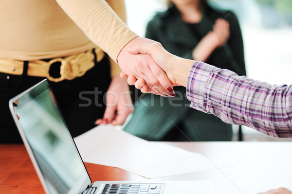 Closing a successful deal with a handshake. Signed contract and applause in the background. Stock photo © zurijeta