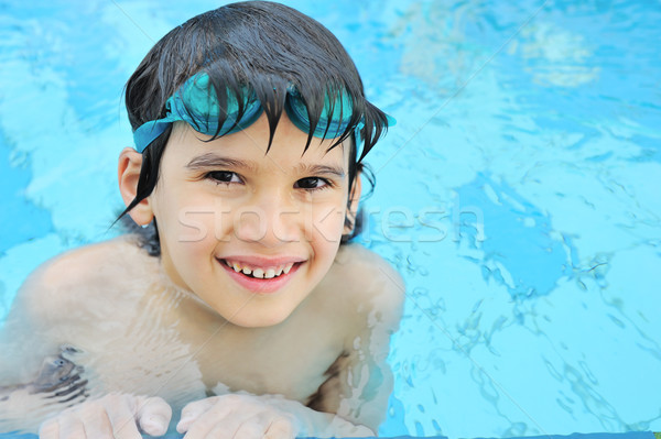 Cute happy kid in pool Stock photo © zurijeta