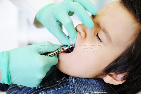 Kid visiting dentist office in hospital for pulling out milk too Stock photo © zurijeta