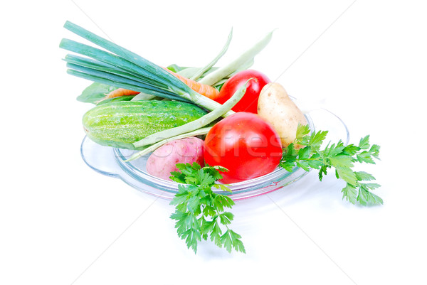 Vegetables on glass plate isolated in white Stock photo © zurijeta