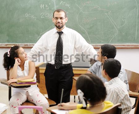 Young male teacher with children in modern school, activities Stock photo © zurijeta