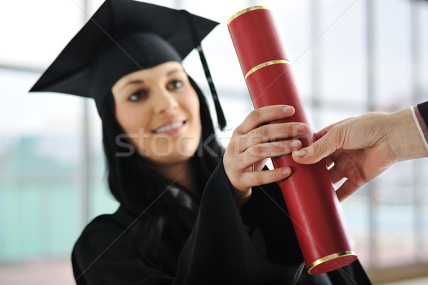 Young female graduating and receiving diploma at university Stock photo © zurijeta
