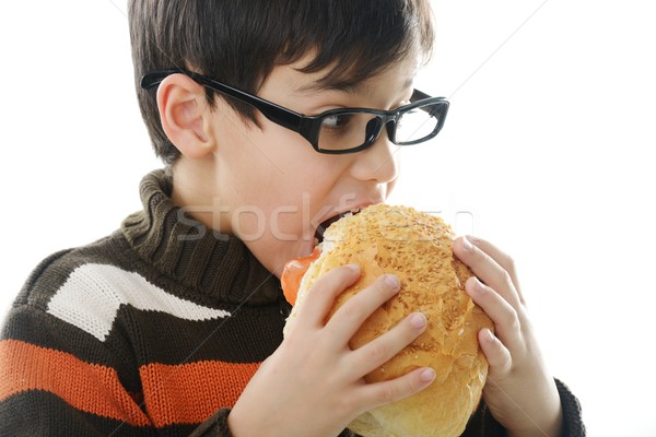 Stock photo: Kid eating bread bun
