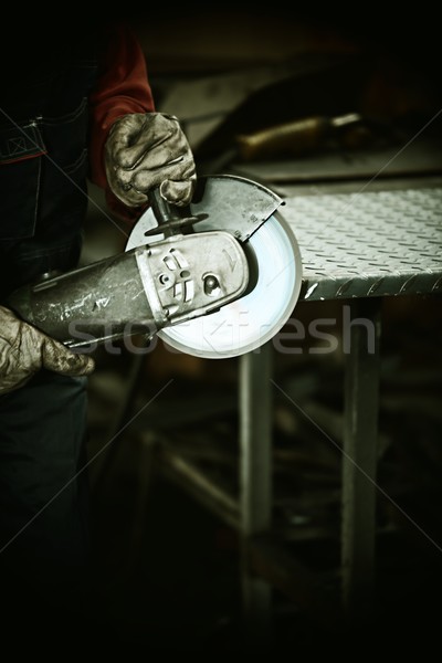 Worker cutting iron with professional tool Stock photo © zurijeta