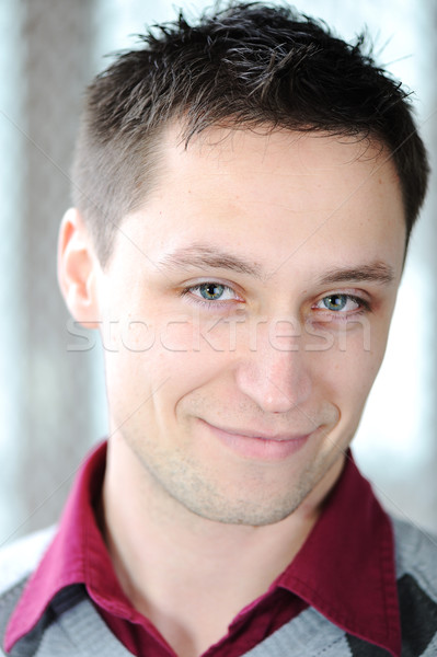 Portrait of young man slightly smiling Stock photo © zurijeta