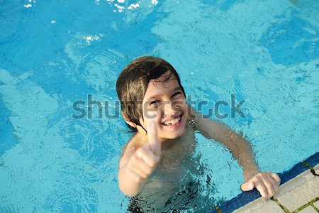 Little happy boy on pool Stock photo © zurijeta
