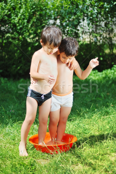 Two kids in basin with water Stock photo © zurijeta