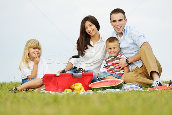 Family with children having picnic time on green meadow in natur Stock photo © zurijeta
