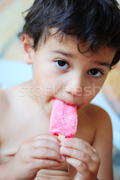 A cute kid with ice cream in mouth Stock photo © zurijeta