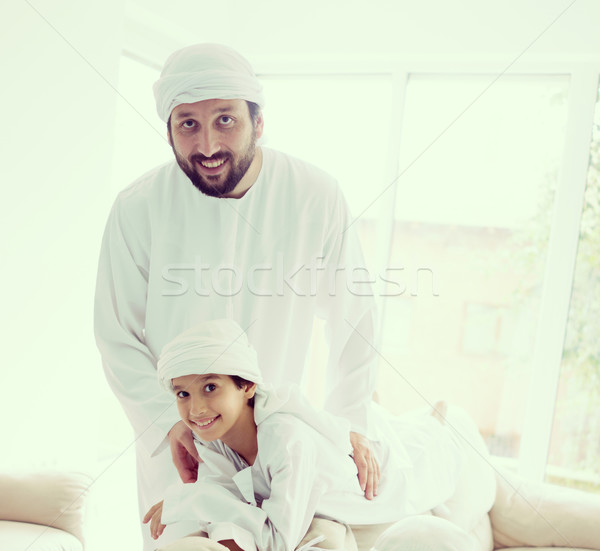 Stock photo: Happy Arabic family having fun at home on sofa