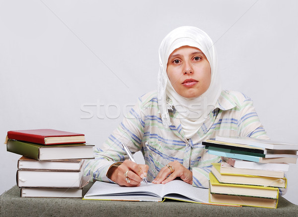 A young muslim woman in traditional clothes in education process Stock photo © zurijeta