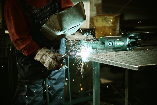 Worker cutting iron with professional tool Stock photo © zurijeta