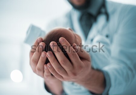 Pediatrician holding a newborn baby boy in hospital Stock photo © zurijeta