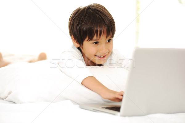 Kid with laptop in bed, happy time Stock photo © zurijeta