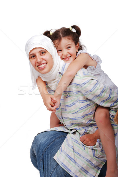 A young muslim woman in traditional clothes with a little girl on back Stock photo © zurijeta