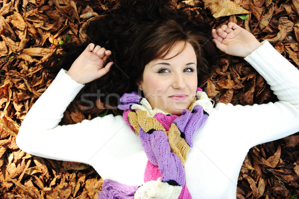 Young beauty girl laying on autumn ground and leaves, perfect face and natural skin Stock photo © zurijeta